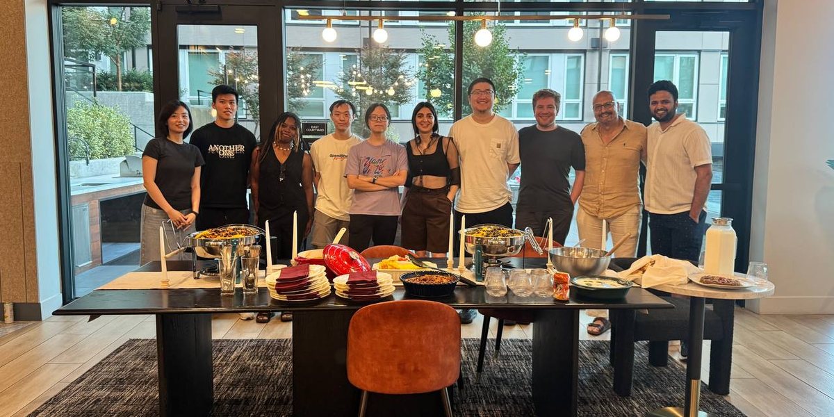 RAIN Lab members around a table of food at a lab dinner